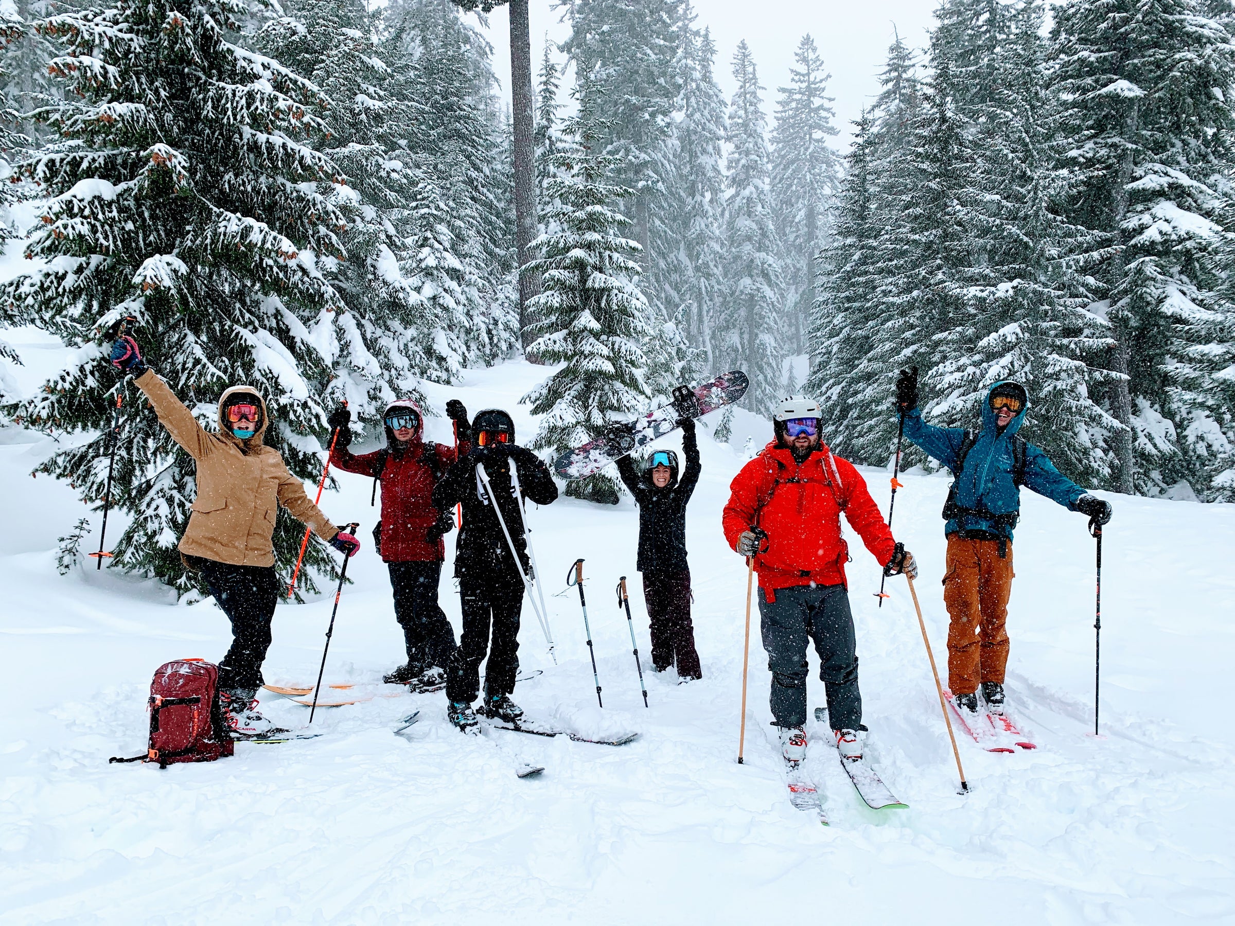 Students show their excitement during an avalanche course while snow comes down around them.