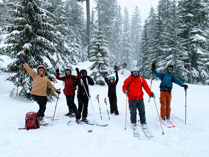 Students show their excitement during an avalanche course while snow comes down around them.