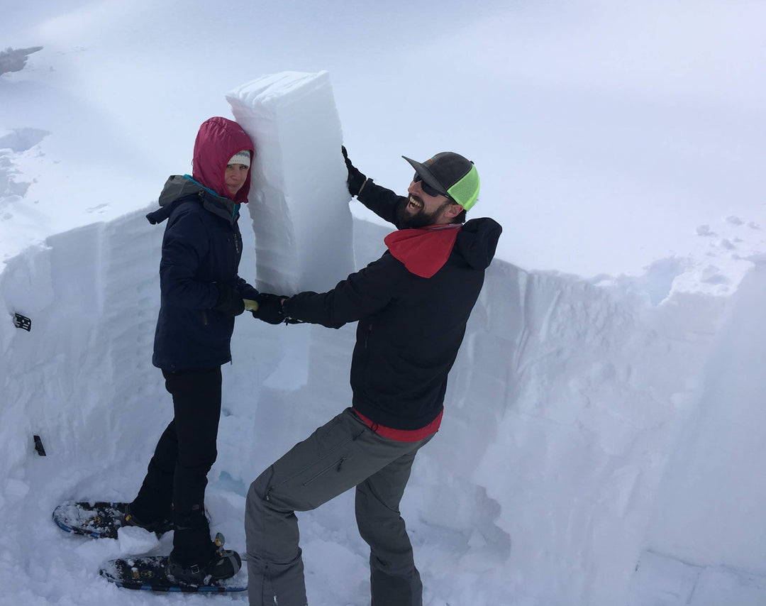 Two people showing the results of their extended column test in an avalanche course.