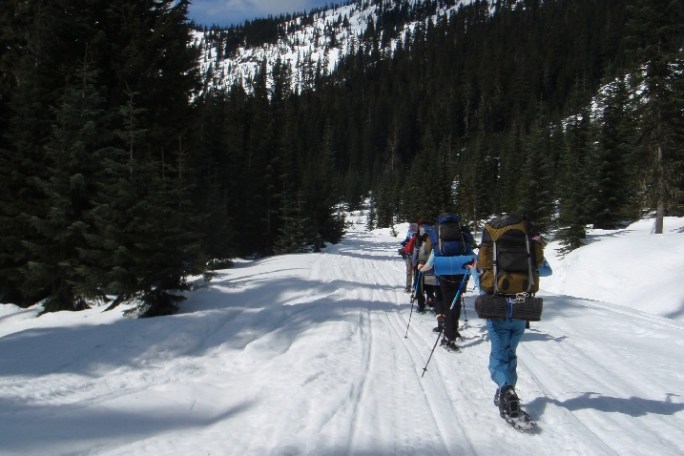 winter hikers in snowshoes hiking a snowy trail in the Cascades