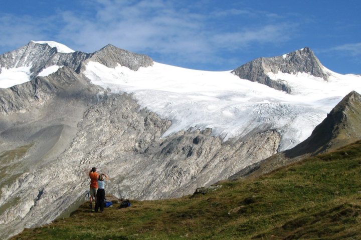 hikers on a Kaf international trip beneath a huge glacier near Grossvenediger, Austria